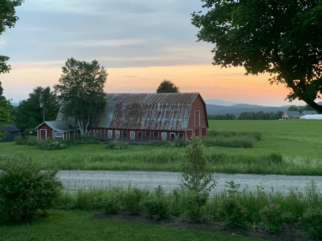 Red barn and field in sunset